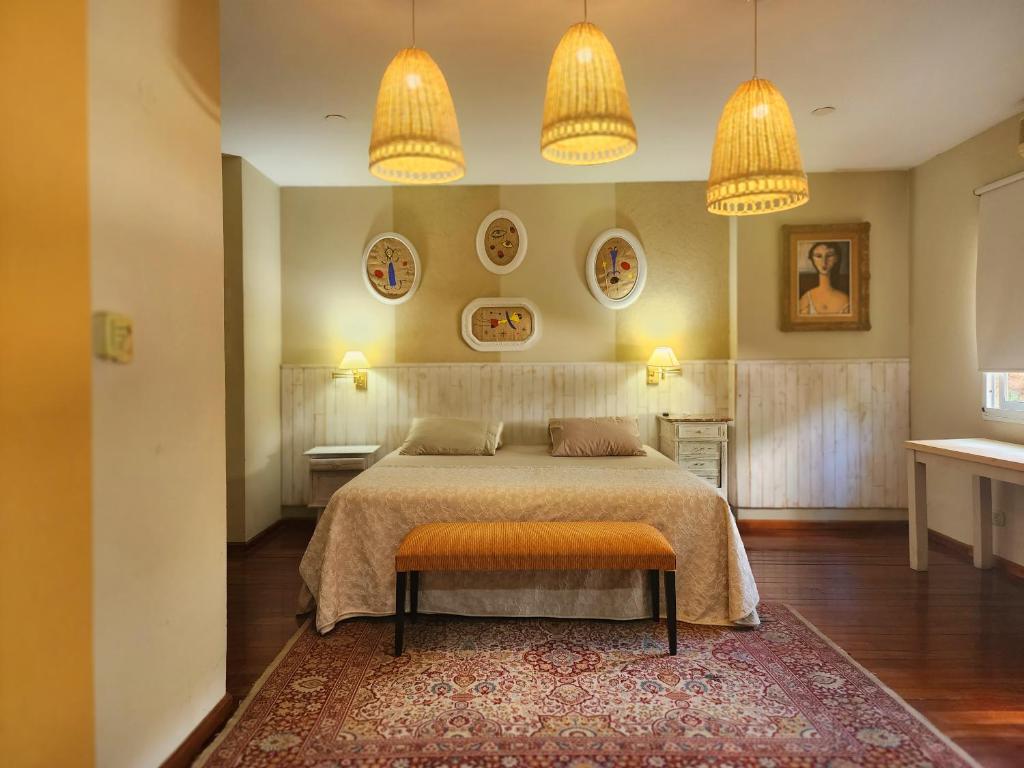 a bedroom with a bed with two lamps and a rug at House Park Hotel Boutique in Santa Fe