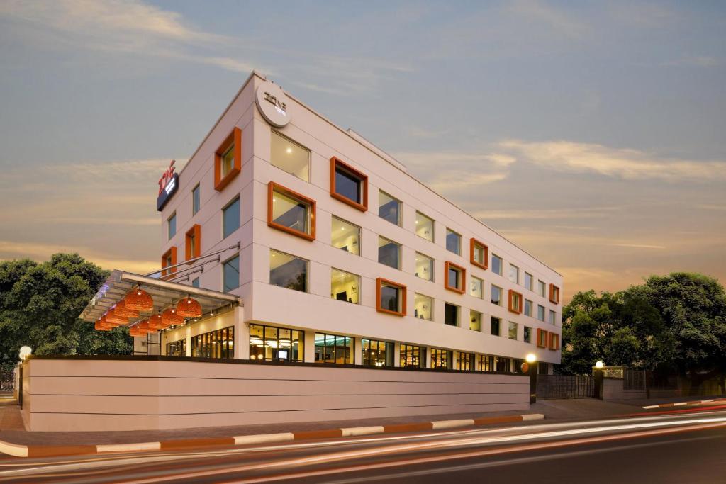 a large white building with windows on a street at Zone By The Park Coimbatore in Coimbatore
