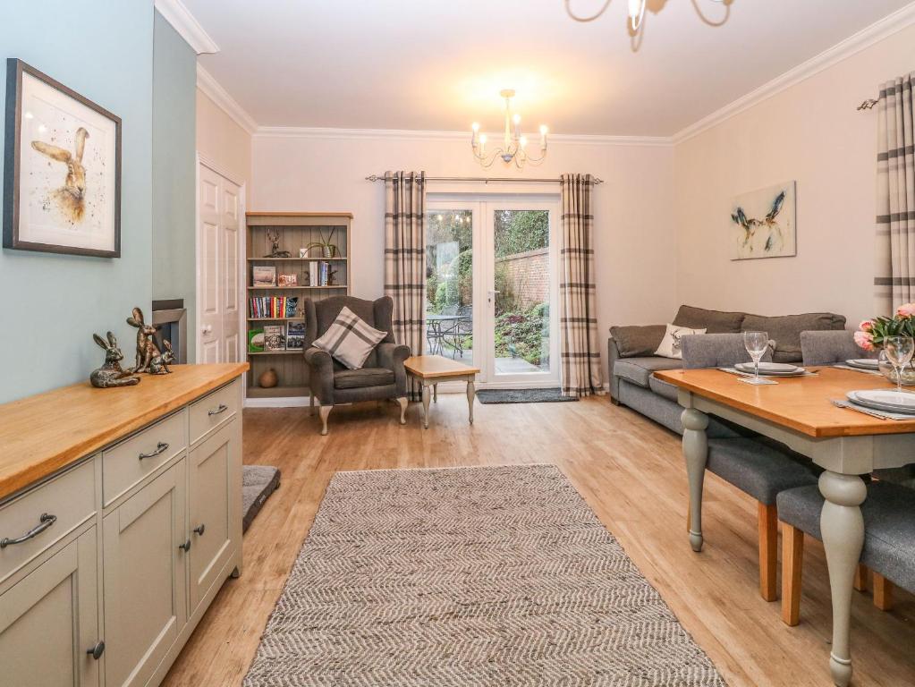 a kitchen and living room with a couch and a table at Brundall House in Norwich