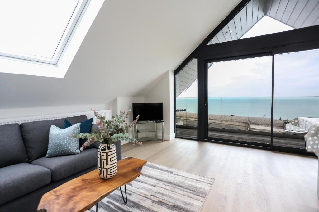 a living room with a couch and a table at Ocean View - Bracklesham Bay in Chichester