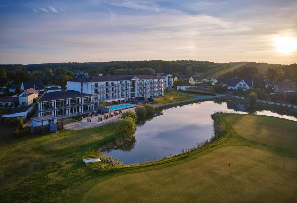 an aerial view of a resort with a pond at Dorint Resort Baltic Hills Usedom in Korswandt