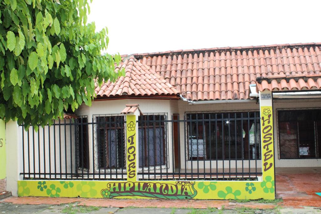a house with a gate withcriptions on it at Hipilandia Amazonas Hostel in Leticia