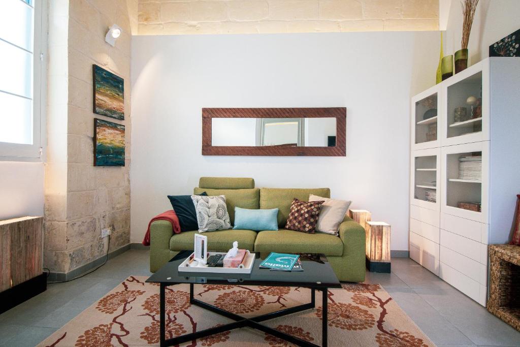 a living room with a couch and a table at 28 Peter in Sliema