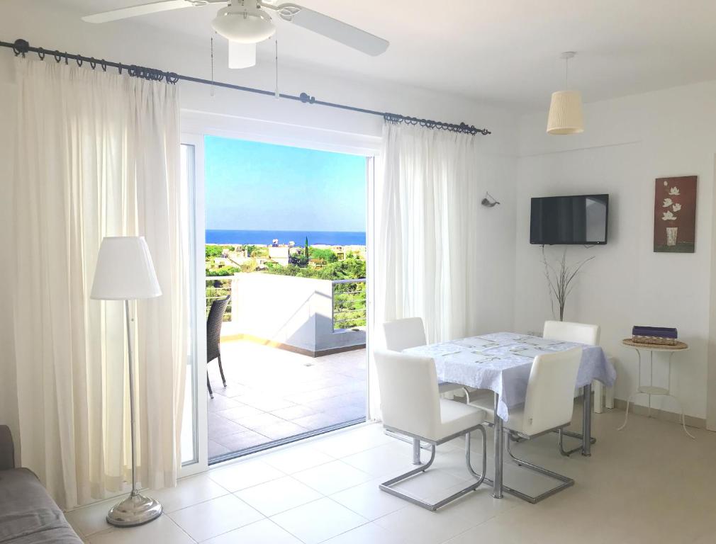 a dining room with a table and a view of the ocean at The Seaterra Reserve Penthouse with mountains&seaviews and rooftop terrace in Akanthou