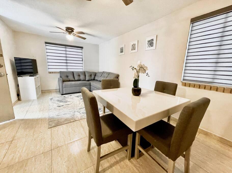 ein Esszimmer mit einem Tisch, Stühlen und einem Sofa in der Unterkunft Acogedor departamento 3 recamaras in Reynosa