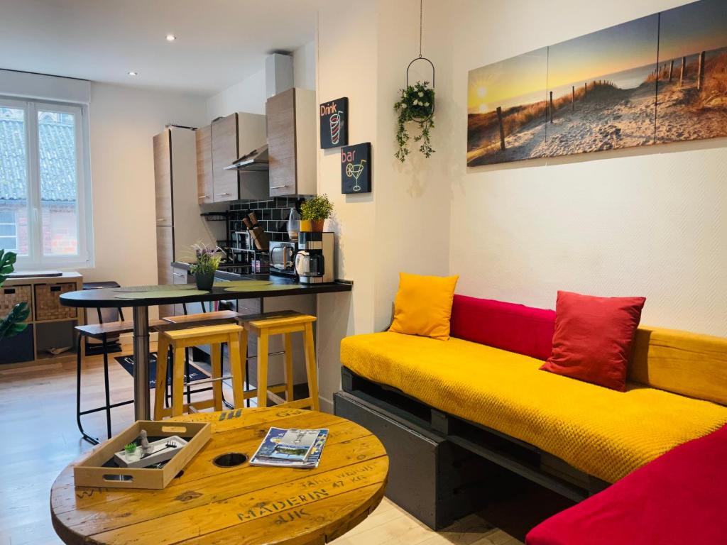 a living room with a yellow couch and a table at Le Duplex 3 chambres - 1P à 7P - Saint Honore in Amiens