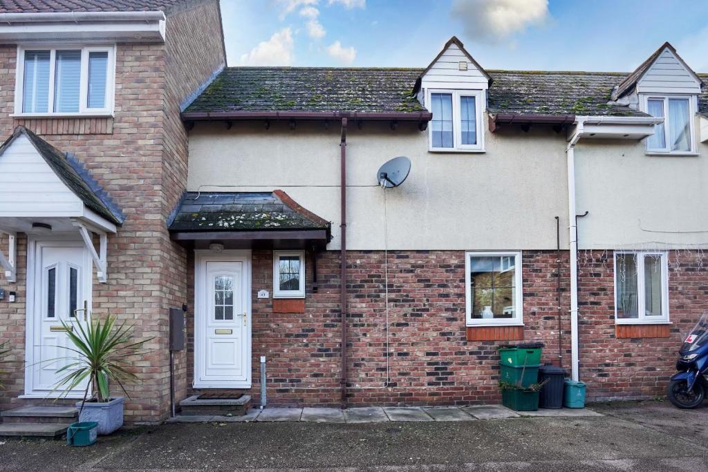 a brick house with a white door at Victoria Gardens in Colchester
