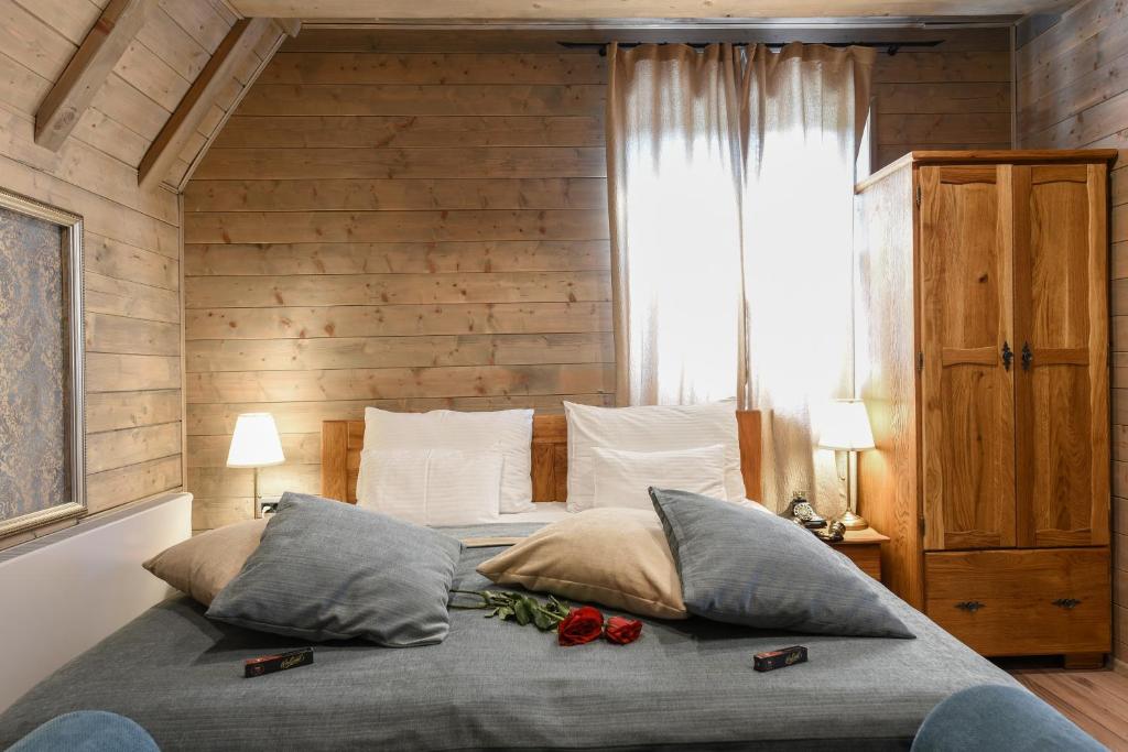 A bed or beds in a room at Ethno Houses Plitvice Lakes Hotel