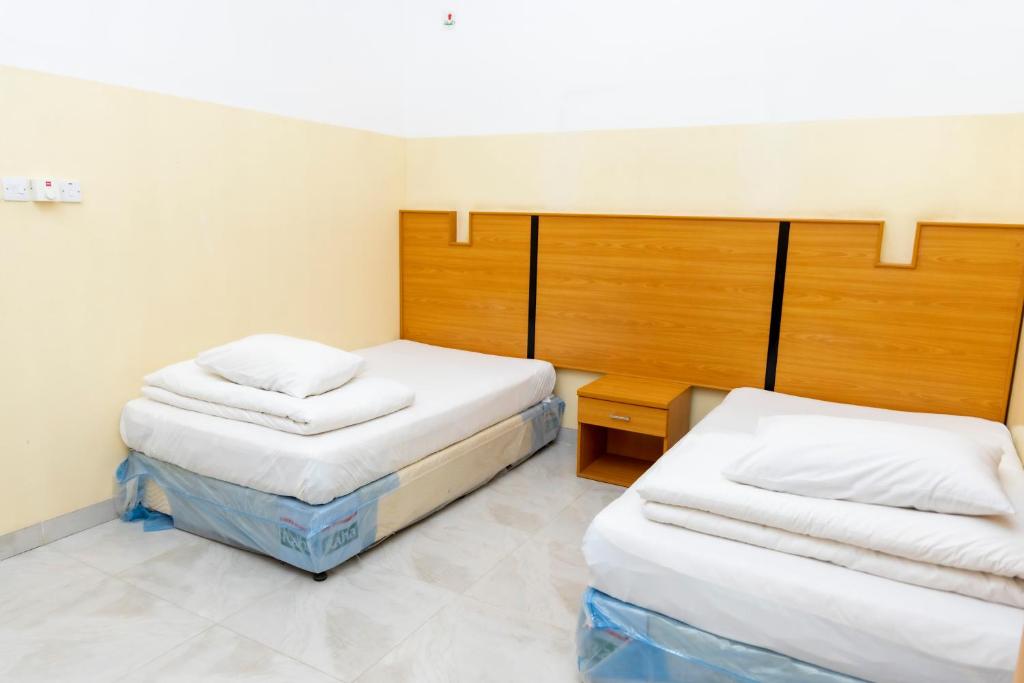 Postel nebo postele na pokoji v ubytování Al Ghaba Line Hotel