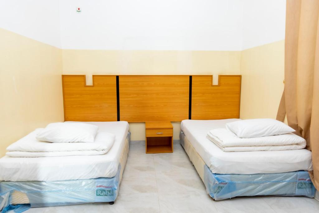 Postel nebo postele na pokoji v ubytování Al Ghaba Line Hotel