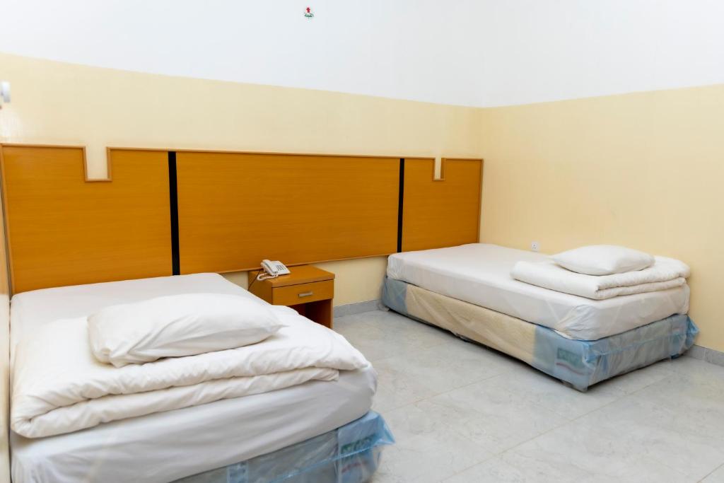Postel nebo postele na pokoji v ubytování Al Ghaba Line Hotel