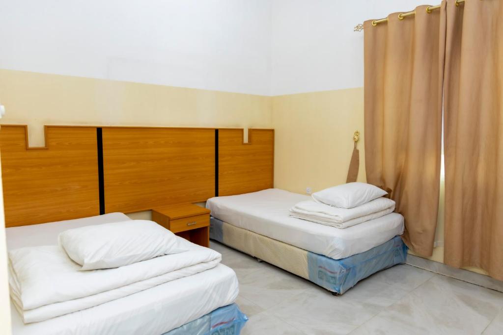 Postel nebo postele na pokoji v ubytování Al Ghaba Line Hotel