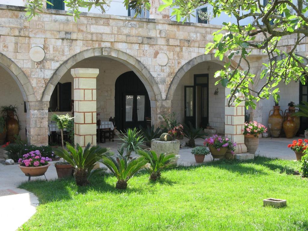 a courtyard of a building with potted plants at Masseria Asciano in Ostuni