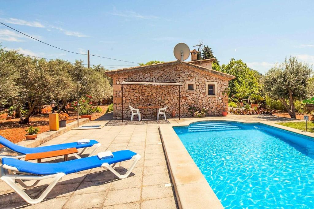 a villa with a swimming pool and a house at Villa Fonto in Pollença