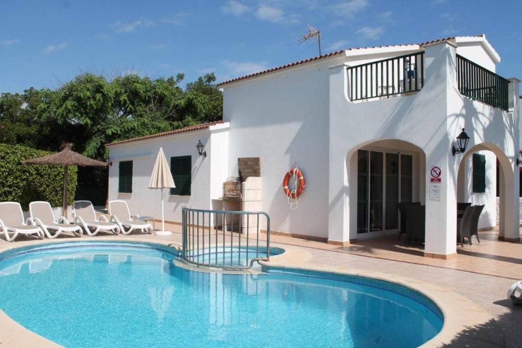 a swimming pool in front of a villa at Villa Elizabet in Cala en Forcat
