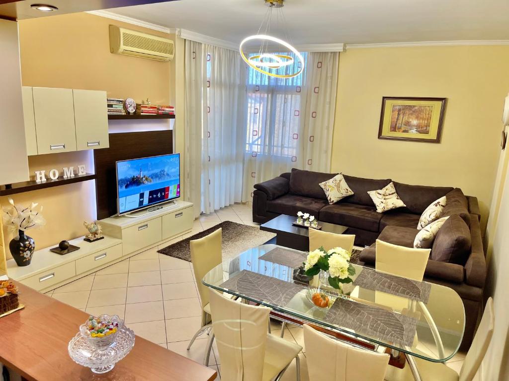 a living room with a table and a couch at Superb Apt Central in Durrës