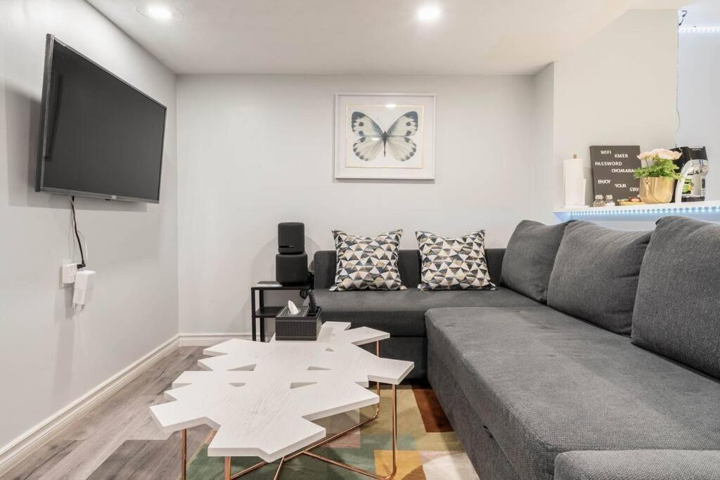 a living room with a couch and a table at Cozy nest basement unit in Hamilton
