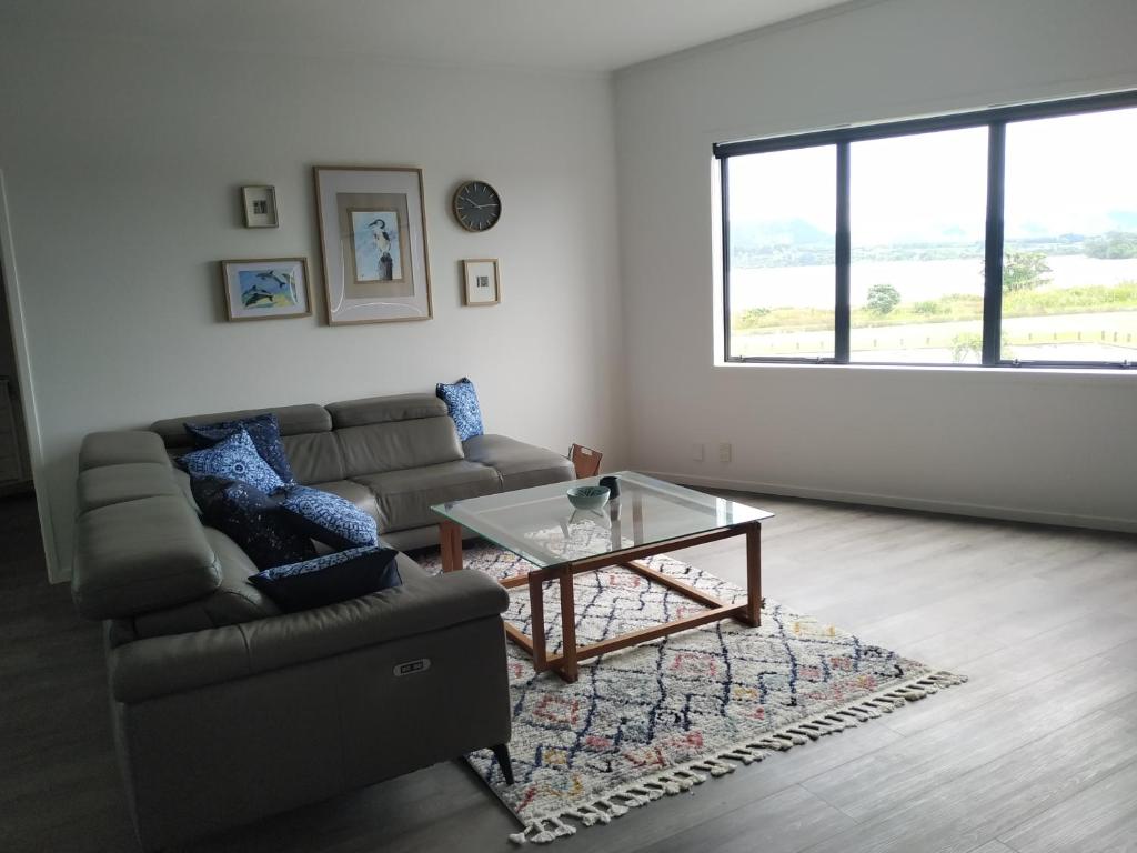 a living room with a couch and a glass table at The Bowentown in Bowentown