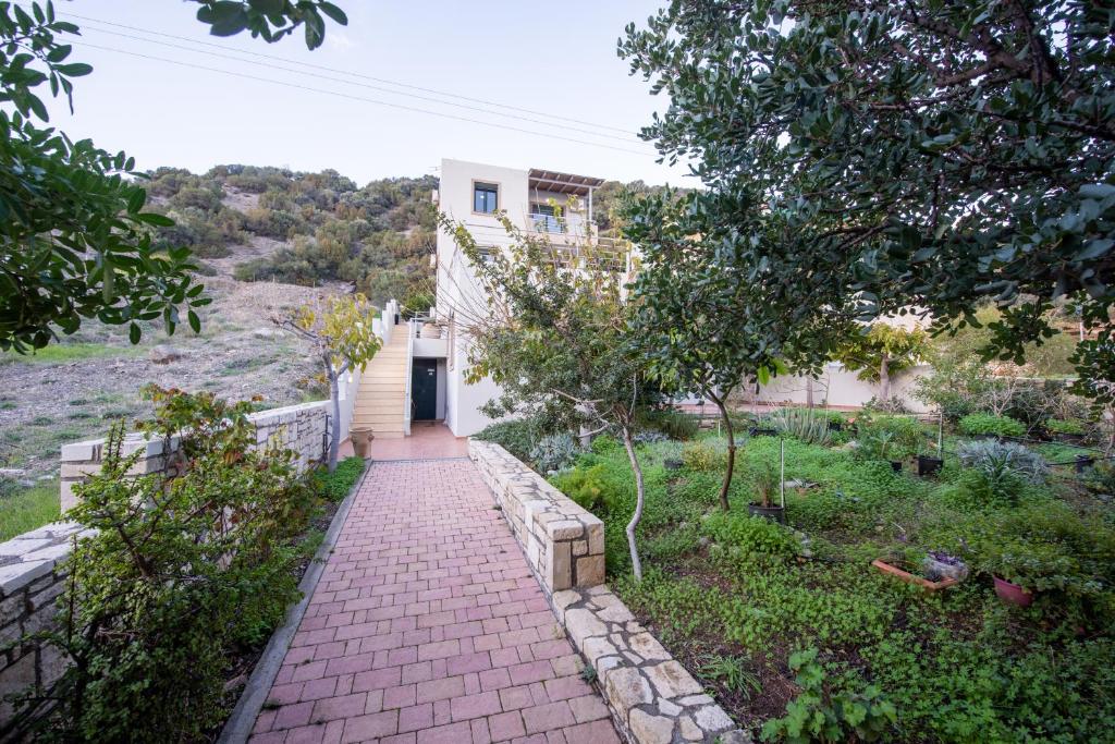 a brick walkway in front of a house at Portela Apartments Kampoula in Keratokampos