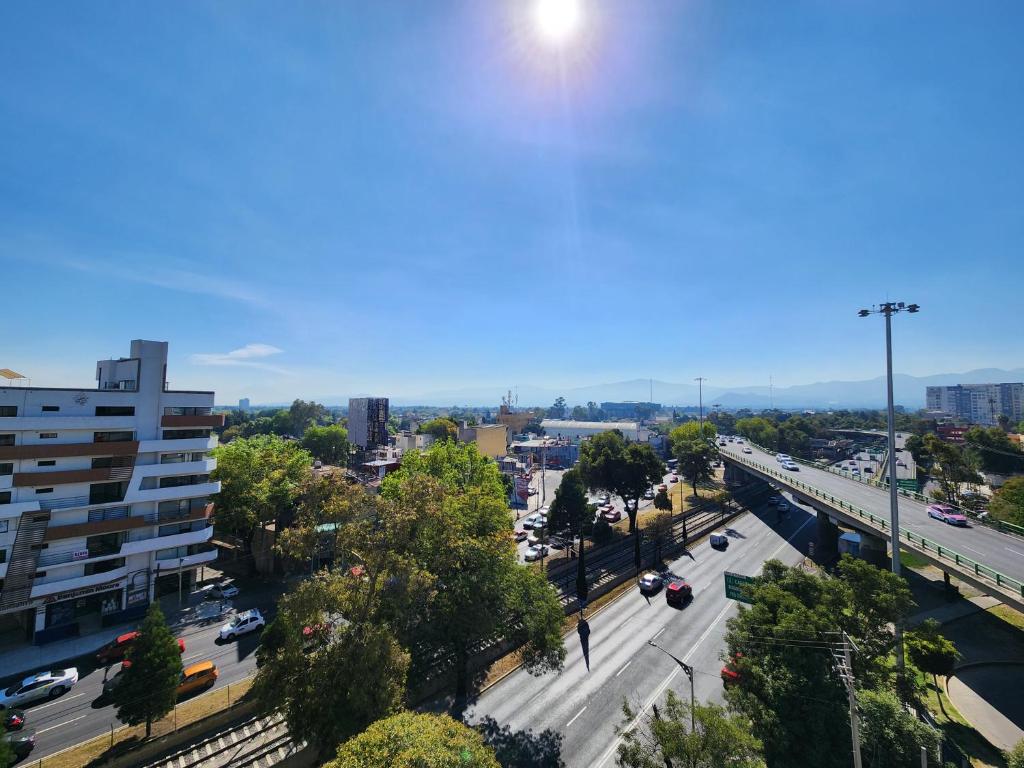 an aerial view of a city with a highway at Hotel Real del Sur in Mexico City