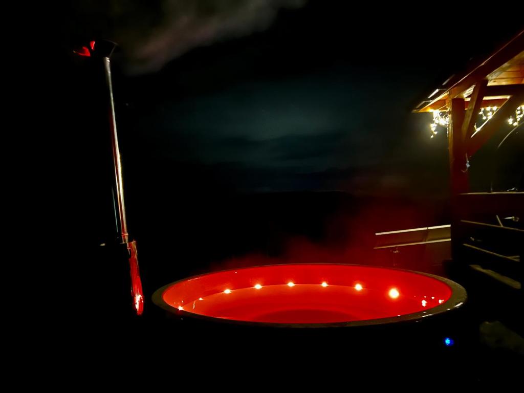 a red bath tub with lights in the dark at Ranczo Targoszów in Targoszów