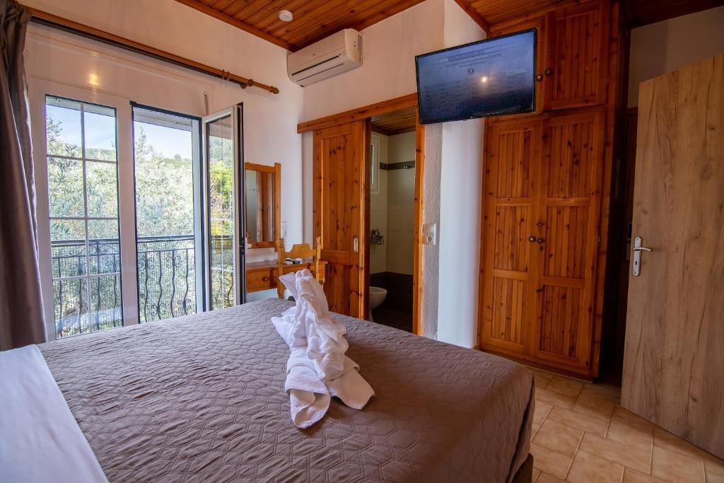 a bedroom with a bed and a large window at Villa Nina in Skiathos Town