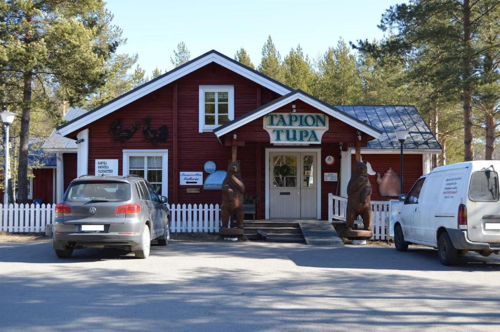 a small red building with cars parked in front of it at Tapion Tupa in Kalajoki