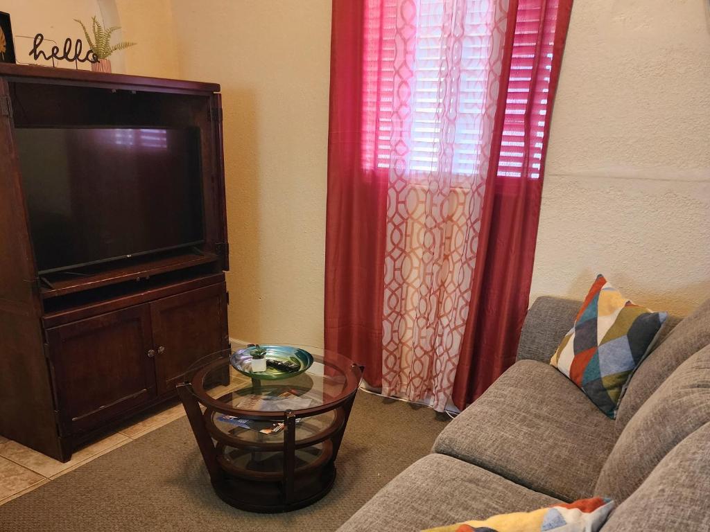 a living room with a couch and a tv at Dolan Springs, Grand Canyon Skywalk in Dolan Springs