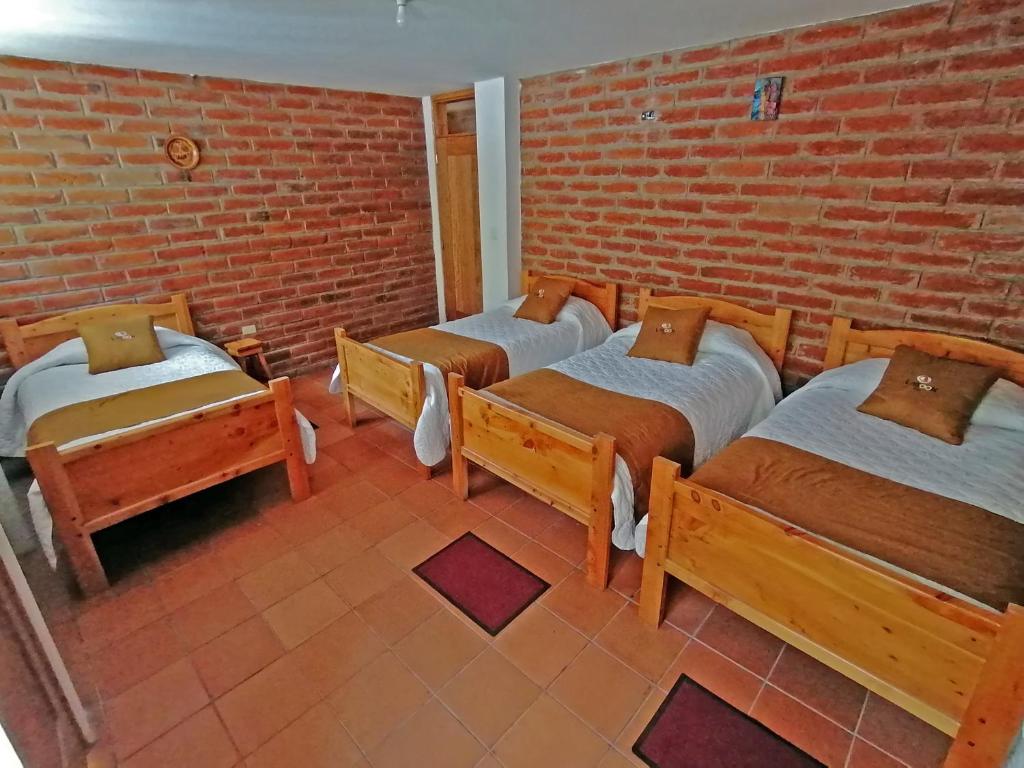 Postel nebo postele na pokoji v ubytování Lagoon Hotel Chugchilan