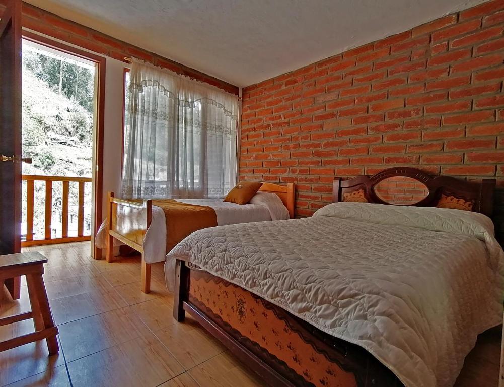 Postel nebo postele na pokoji v ubytování Lagoon Hotel Chugchilan