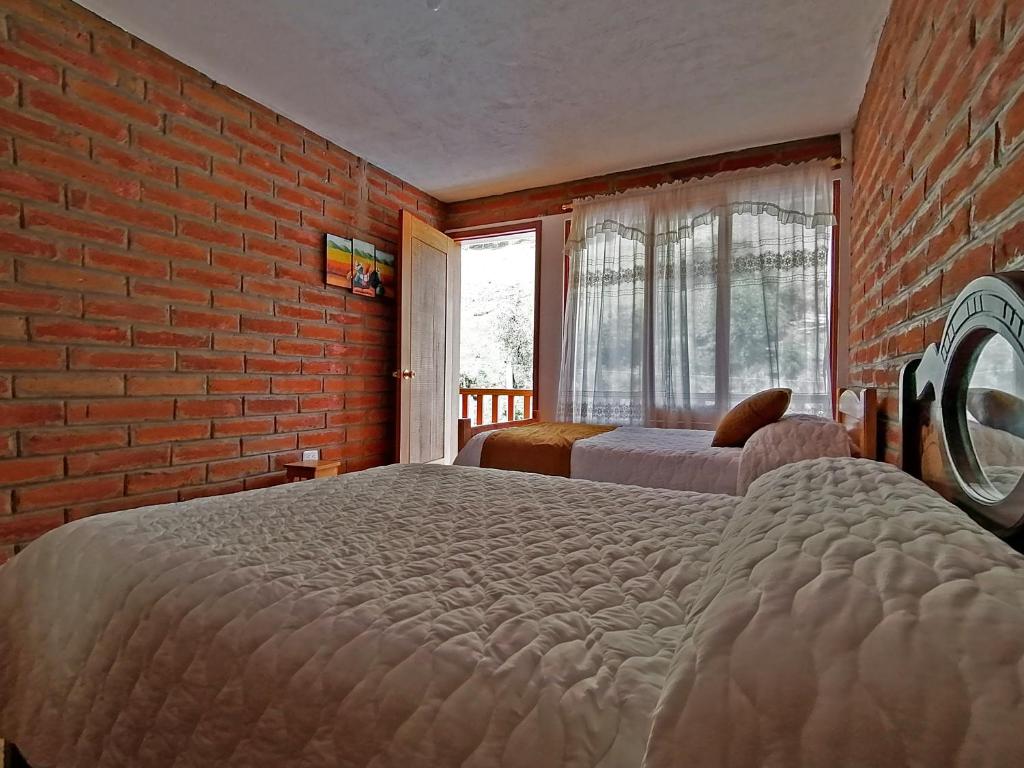 Postel nebo postele na pokoji v ubytování Lagoon Hotel Chugchilan