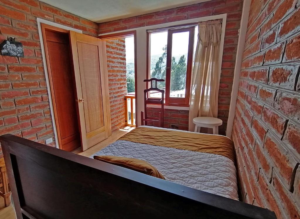 Postel nebo postele na pokoji v ubytování Lagoon Hotel Chugchilan