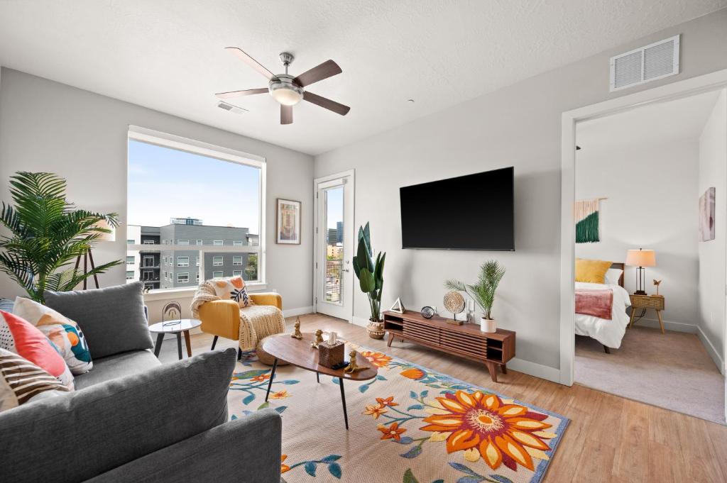 a living room with a couch and a tv at King BD-City View-SLC Walking Wonderland- in Salt Lake City