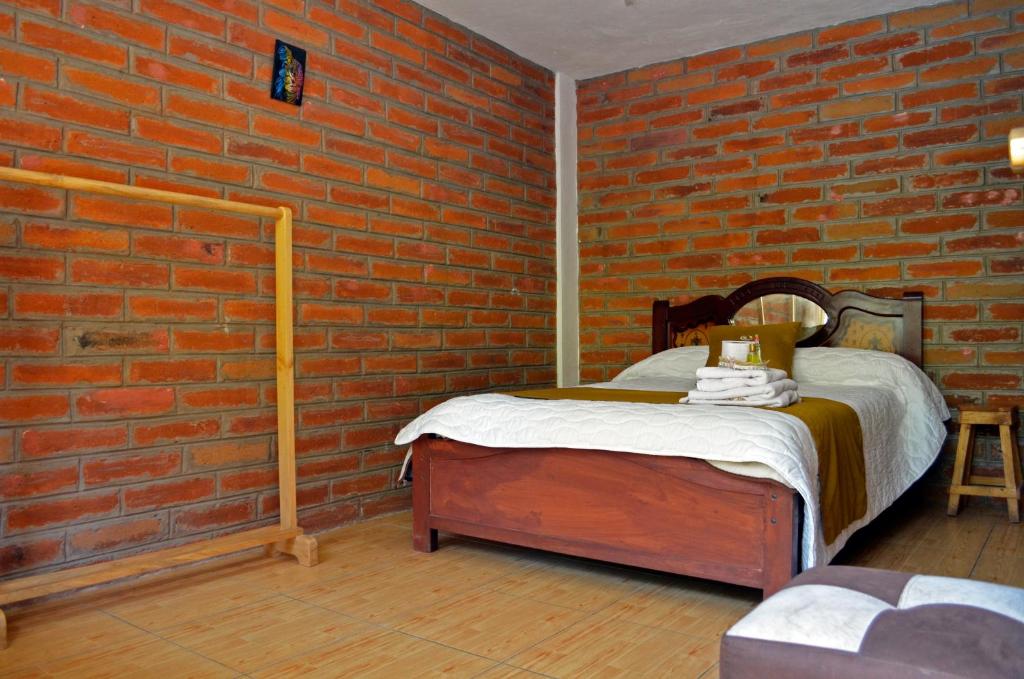 Postel nebo postele na pokoji v ubytování Lagoon Hotel Chugchilan