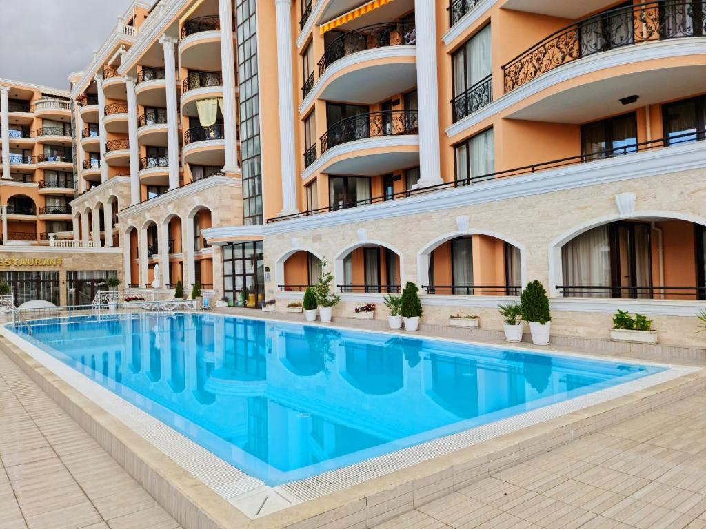 a swimming pool in front of a building at GH Apartment Admiral Sveti Vlas in Sveti Vlas