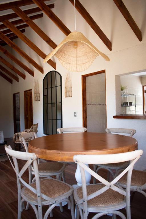 a dining room with a wooden table and chairs at Cabañas Montenegro in Villarrica