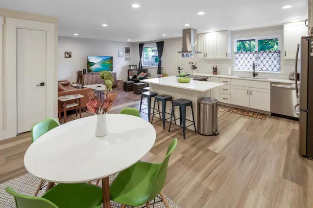 a kitchen and living room with a white table and chairs at VogueTown in Boise