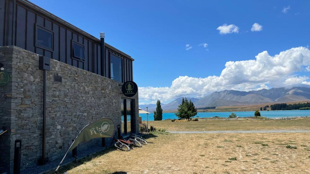 a building with a view of a lake and mountains at Tekapo Lakefront Apartments in Lake Tekapo