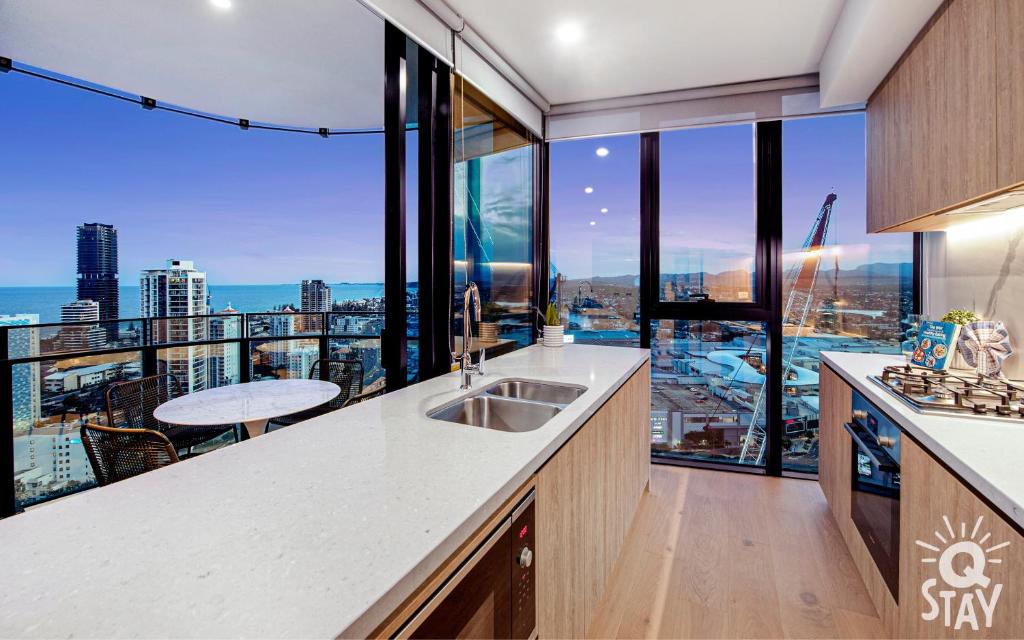 a kitchen with a view of a city skyline at 3 Bedroom Private Apartments at Casino - Q Stay in Gold Coast