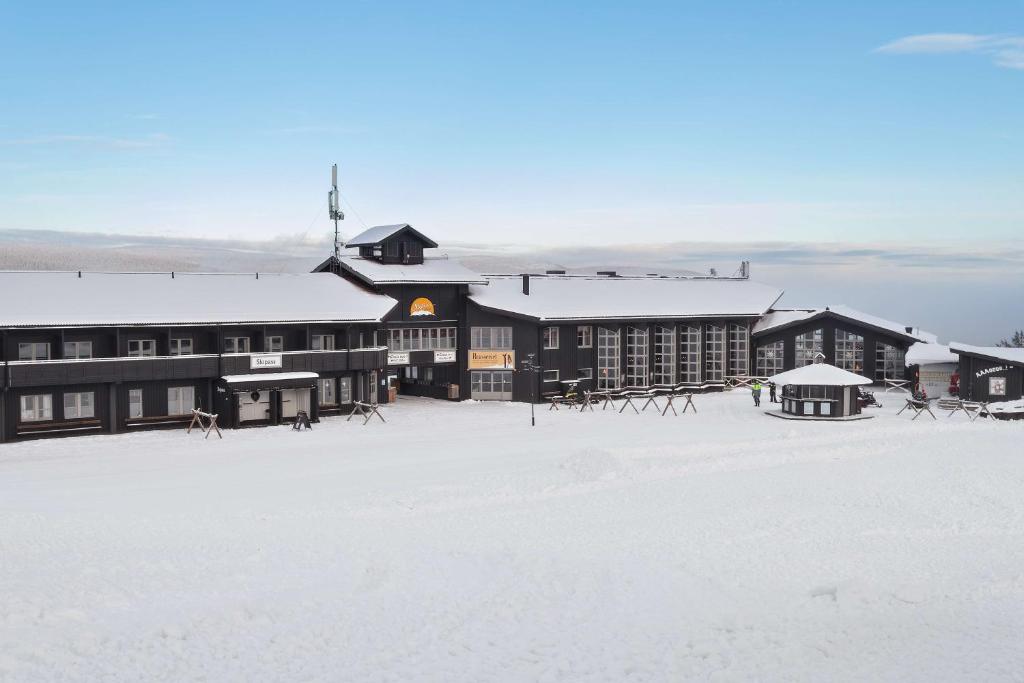 a large building in the snow with a snow covered field at Best Western Stoten Ski Hotel in Stöten