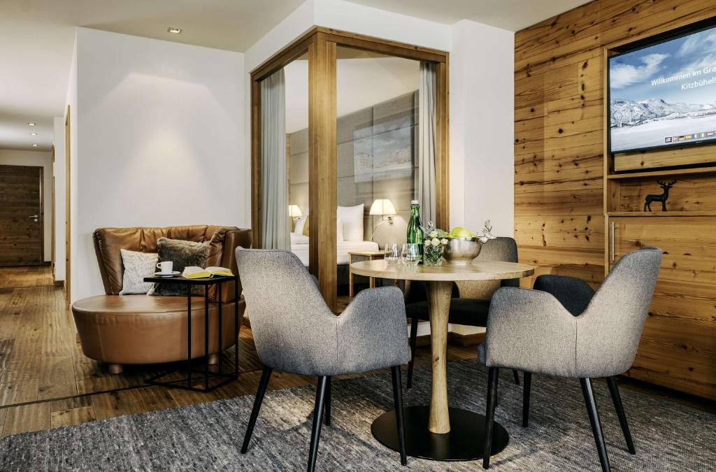 a living room with a table and chairs at Grand Tirolia Kitzbühel - Member of Hommage Luxury Hotels Collection in Kitzbühel