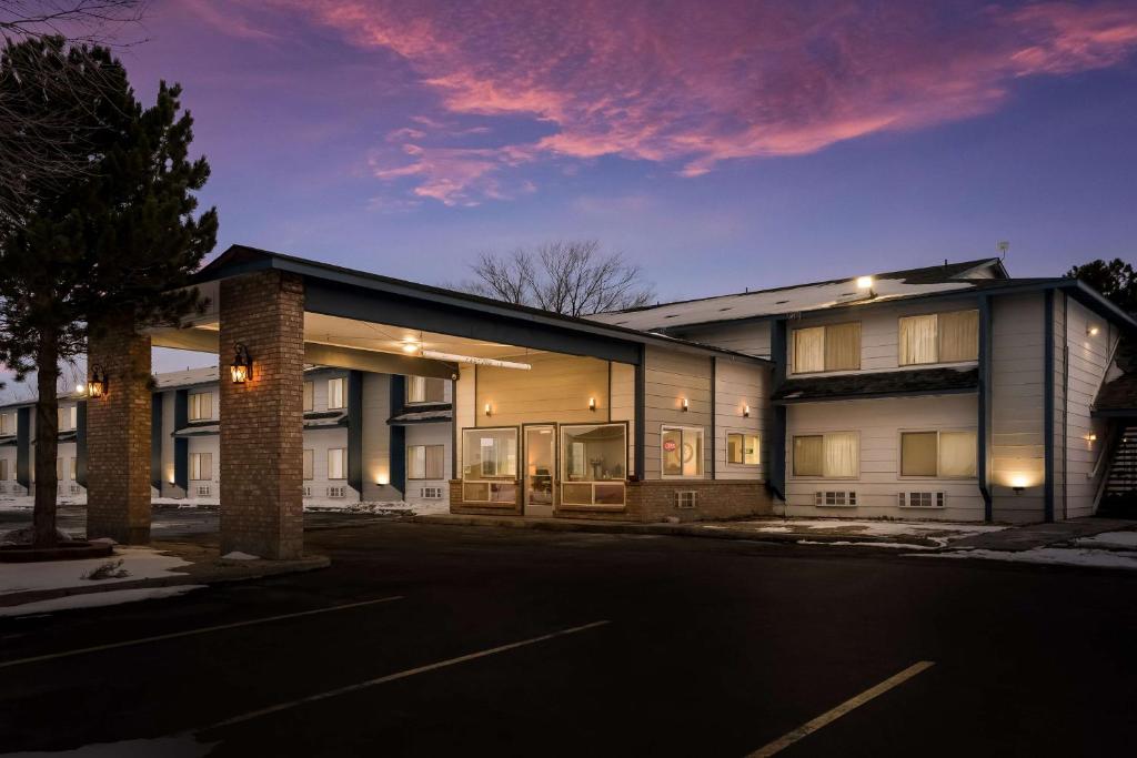 a building with a parking lot in front of it at SureStay Hotel by Best Western Wells in Wells