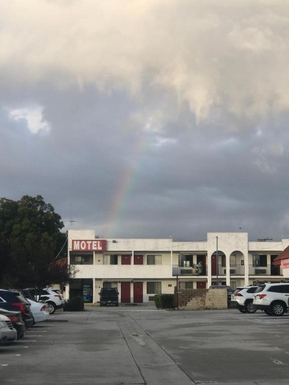 a motel with cars parked in a parking lot at Eunice Plaza Motel in El Monte