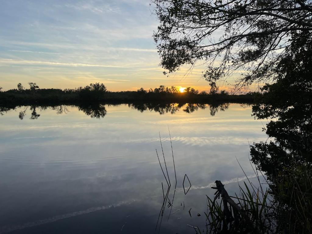 a view of a lake with the sunset in the background at Beautiful waterfront condo 1 in Punta Gorda