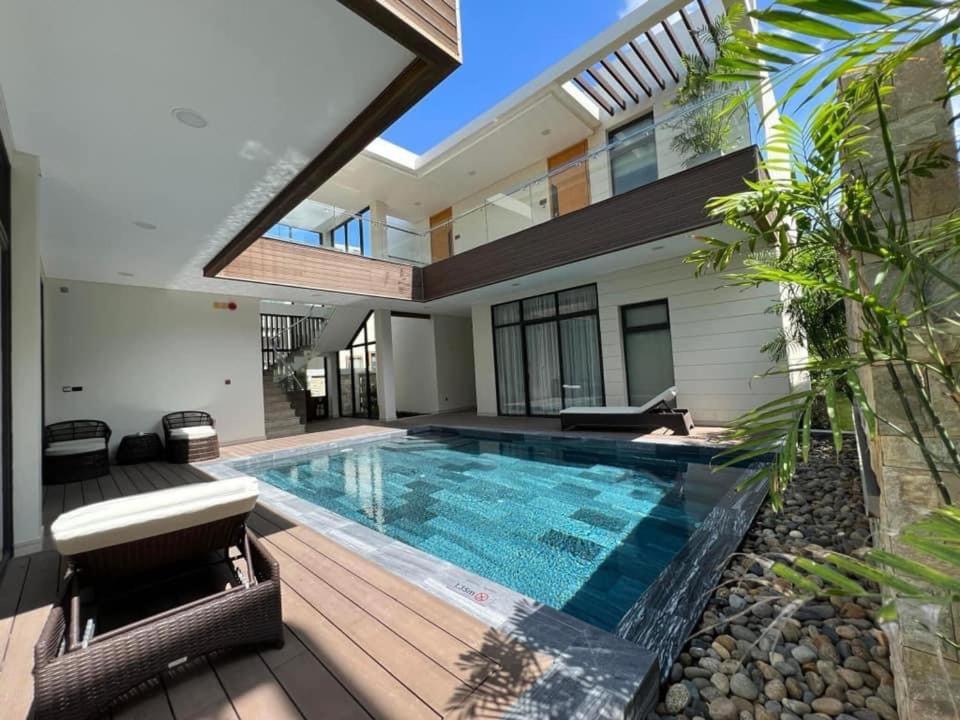 a swimming pool in the backyard of a house at Residence Inn Villa Cam Ranh in Cam Ranh
