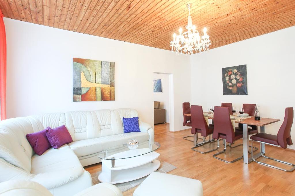 a living room with a white couch and a table at Mozart Apartments in Vienna