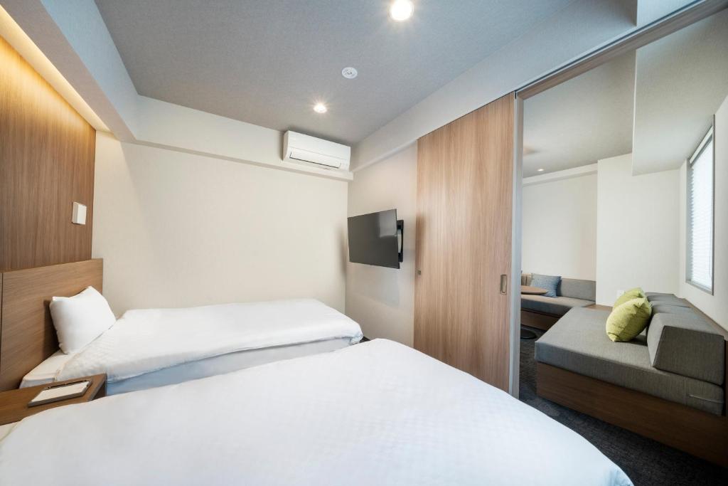 Postel nebo postele na pokoji v ubytování KOKO HOTEL Residence Asakusa Tawaramachi