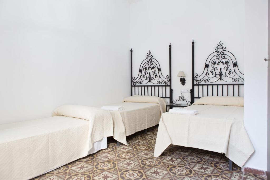 Postel nebo postele na pokoji v ubytování Hostal Palacio del Corregidor