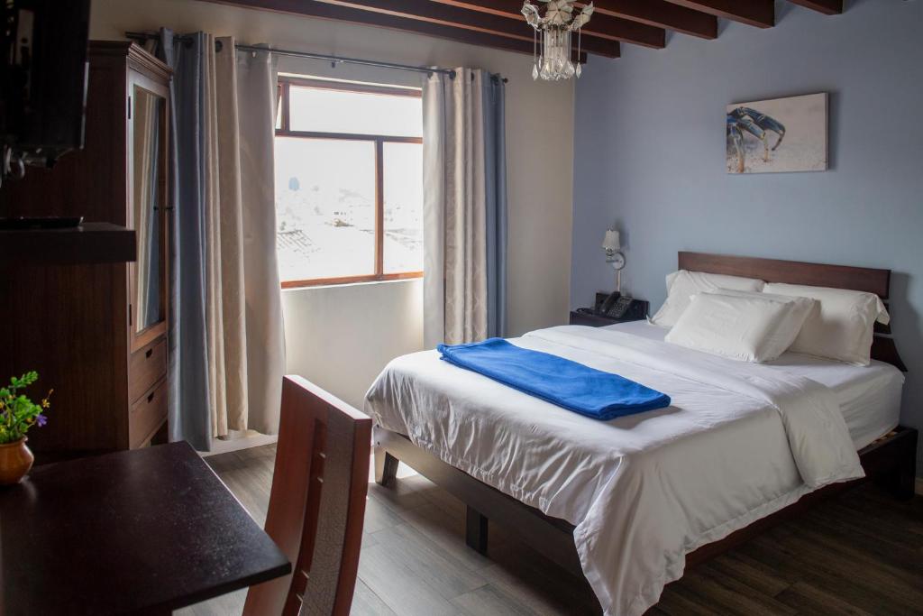 Postel nebo postele na pokoji v ubytování Hotel Colonial San Agustin