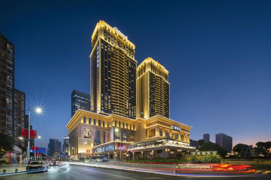 a large building in a city at night at Oakwood Residence Foshan in Foshan